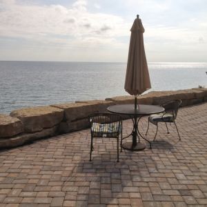 Large paver patio embedded between terraced walls. Patio space provides enhanced views of Lake Michigan.