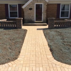 Small seating areas and front walk installed in front of residence using County Materials Elements 4"x8" pavers.