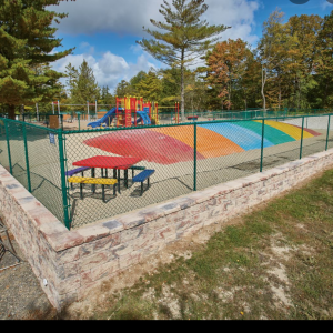 Retaining wall installed around new play structure at Jellystone Park in Caledonia