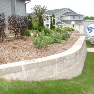 Block retaining wall and plantings installed at a Mount Pleasant office building.