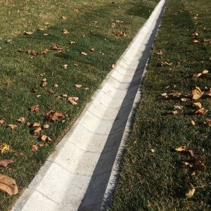 The ditch block is installed at a slight pitch to promote drainage towards a designated direction.  **Block sold by Bark River Concrete Products**