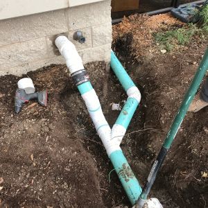 PVC connected to downspouts carry water away from building in Caledonia.