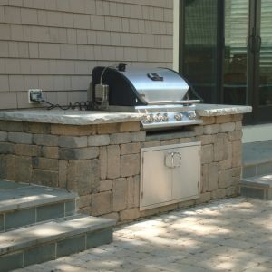 Extend your kitchen into the outdoors. The stainless steel grill is built into a cabinet made of Summit stone block and a chiseled limestone counter top. Racine, WI
