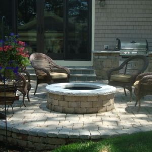 An outdoor kitchen and fire pit installed by Dresen Landscape Contractors, Racine, WI.