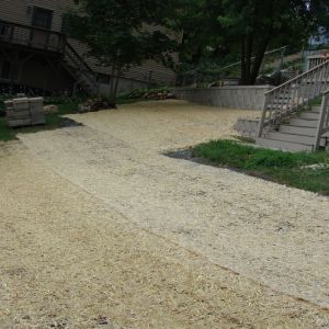 On sloped areas, straw matting is installed to prevent soil and seed from eroding.