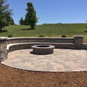 Unilock Westport fire pit space with Estate Wall seating and Ledgestone caps in Waterford.