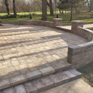 Unilock Brussels paver patio (Sierra color) with Brussels Dimensional seat walls. Installed in Caledonia.