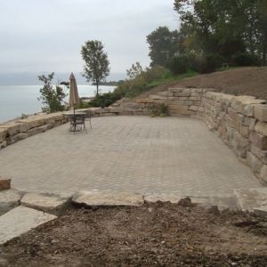 Paver patio on Lake Michigan installed between terraced walls expands useable space along bluff. Walls also constructed by Dresen Landscaping.