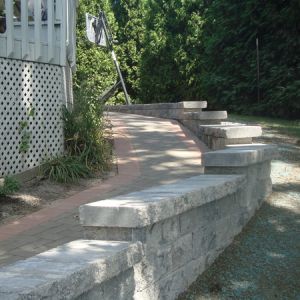 Holland paver ramp helps provide a gentle slope for wheelchair access to lower entrance.