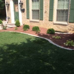 After image: Old hedges are replaced with a fresh and low maintenance landscape.