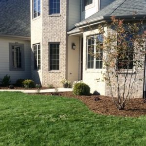 A new home is given a completed look by installing shredded hardwood mulch beds surrounding the house.