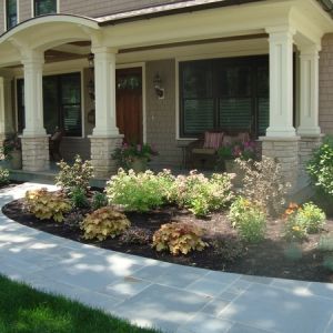 Perennials and ornamental grasses mixed with flowering shrubs add lots of color to new home.