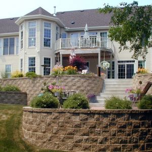 Four curved StoneWall Select retaining walls are installed in a terraced effect to provide strength and stability, yet have a less massive look than a single wall. (Racine, WI)