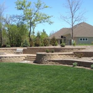 A slope is turned into usable planting and entertaining space with terraced County Materials block retaining walls in Mount Pleasant, WI.