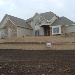 Retaining walls turn a front yard slope into manageable space. (Racine, WI)