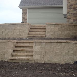 Steps made of StoneWall retaining wall blocks and cap provide easy access to the side yard.