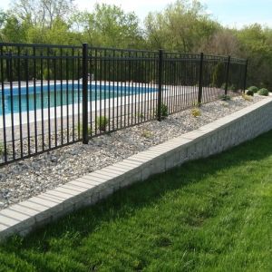 A retaining wall made of StoneWall Select block stabilizes the area around an in-ground pool. (Racine, WI)