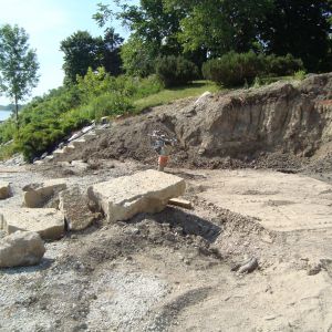 Lannon stone steps (background) and tiered wall (foreground) installed to prepare for upper wall and paver patio along Lake Michigan shoreline in Wind Point.