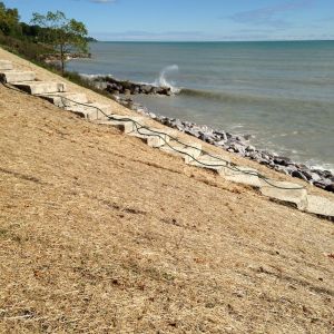 Reducing erosion on slope to Lake Michigan with SR-1 Erosion Blanket, seed and steps to access shoreline in Somers.