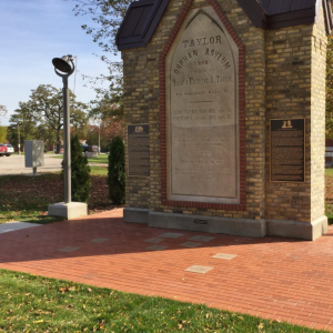 Install memorial paver bricks around Taylor Home keystone monument in Mount Pleasant.