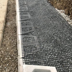 Geo-grid mesh placed between layers of block for stability of retaining wall in Mount Pleasant