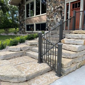 Rustic Gold Outcropping stone steps installed at a front entry to a residence in Caledonia