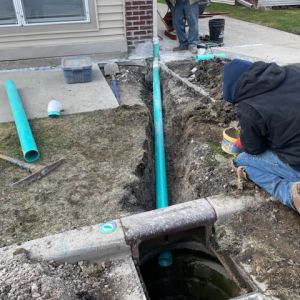 Core drilling downspout into storm sewer with 4" SDR-35 PVC