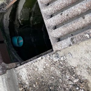 SdR-35 drain pipe empties into storm sewer in street curb.
