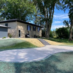 Curvy paver patio installed using County Materials Grand Discover Pavers in Allure. Installed in Caledonia, WI.